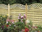 Garden fence with concrete gravelboards and wooden posts, with trellis top.