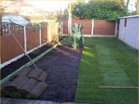 Garden fence using wooden panels, concrete posts and concrete gravel boards. Also turf laying.